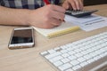 Businessman working on office desk with Calculator, a computer, a pen and document. Man, Businessman counting money and making cal Royalty Free Stock Photo