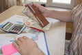 Man working on office desk with Calculator, a computer, a pen and document. Man, counting money and making calculations Royalty Free Stock Photo