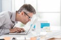 Businessman working at office desk, he is staring at the laptop screen close up and holding his glasses, workplace vision problems Royalty Free Stock Photo