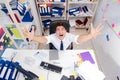 Businessman working in the office with piles of books and papers Royalty Free Stock Photo