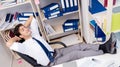 Businessman working in the office with piles of books and papers Royalty Free Stock Photo