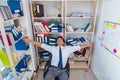 Businessman working in the office with piles of books and papers Royalty Free Stock Photo