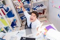 Businessman working in the office with piles of books and papers Royalty Free Stock Photo