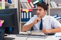 Businessman working in the office with piles of books and papers Royalty Free Stock Photo