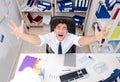 Businessman working in the office with piles of books and papers Royalty Free Stock Photo