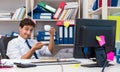 Businessman working in the office with piles of books and papers Royalty Free Stock Photo