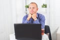 Businessman working in office, sitting at table with a laptop. Royalty Free Stock Photo