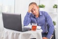 Businessman working in office, sitting at table with a laptop fr Royalty Free Stock Photo