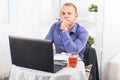 Businessman working in office, sitting at table with a laptop, looking camera. Royalty Free Stock Photo