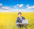 Businessman working outdoor in flower field Royalty Free Stock Photo