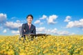 Businessman working outdoor in flower field Royalty Free Stock Photo
