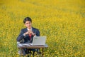 Businessman working outdoor in flower field Royalty Free Stock Photo