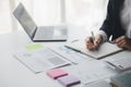 Businessman working in a private office, she is reviewing the company's financial documents sent from the finance department