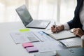 Businessman working in a private office, she is reviewing the company's financial documents sent from the finance department