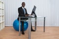 Businessman Working Sitting On Pilates Ball