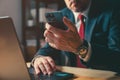 Businessman working with smartphone and laptop computer in office Royalty Free Stock Photo