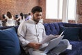 Businessman Working On Sofa In Modern Creative Office Royalty Free Stock Photo