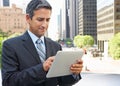 Businessman Working On Tablet Computer Outside Office Royalty Free Stock Photo