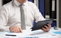 Businessman working with tablet pc, calculating, reading and writing reports. Office employee, table closeup. Business financial Royalty Free Stock Photo