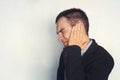 A businessman or working with tinnitus. Man with earache is holding his aching ear body pain concept. copy space