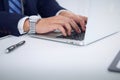 Businessman working by typing on laptop computer. Man`s hands on notebook or business person at workplace. Employment o Royalty Free Stock Photo