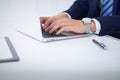 Businessman working by typing on laptop computer. Man`s hands on notebook or business person at workplace. Employment o Royalty Free Stock Photo