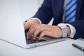 Businessman working by typing on laptop computer. Man`s hands on notebook or business person at workplace. Employment o Royalty Free Stock Photo