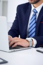 Businessman working by typing on laptop computer. Man`s hands on notebook or business person at workplace. Employment o Royalty Free Stock Photo