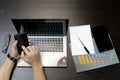 A man prints on a laptop, lying next to the phone, tablet glasse Royalty Free Stock Photo