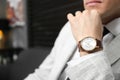 Businessman with wrist watch on blurred background, closeup. Space for text Royalty Free Stock Photo