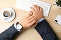 Businessman with wrist watch working at office table Royalty Free Stock Photo