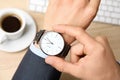 Businessman with wrist watch working at office table, closeup. Royalty Free Stock Photo