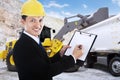 Businessman writes on a clipboard at mining site Royalty Free Stock Photo