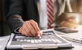 Businessman writes information businessman working on laptop computer writing business plan. Royalty Free Stock Photo