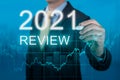 Businessman writes 2021 review words. businessman writes 2021 results on virtual screen. economic indicators, overcoming the Royalty Free Stock Photo