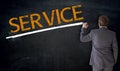 Businessman writes service on blackboard concept Royalty Free Stock Photo