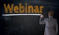 Businessman writes webinar on blackboard concept Royalty Free Stock Photo