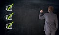 Businessman writing with checkbox concept on blackboard Royalty Free Stock Photo