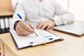 Businessman writing on clipboard at the office Royalty Free Stock Photo