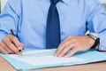 Businessman writing a contrat before signing it Royalty Free Stock Photo