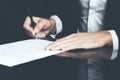 Businessman writing correspondence or signing a document using a fountain pen Royalty Free Stock Photo