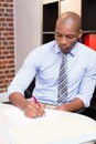 Businessman writing document at desk Royalty Free Stock Photo