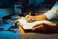 Businessman writing on document while working late in office. Royalty Free Stock Photo