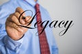 Businessman writing Legacy word on virtual screen Royalty Free Stock Photo