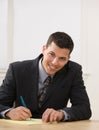 Businessman writing on legal pad taking notes Royalty Free Stock Photo