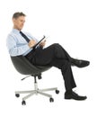 Businessman Writing In Note Pad While Sitting On Office Chair Royalty Free Stock Photo