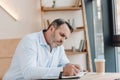 concentrated mature businessman writing in notebook Royalty Free Stock Photo