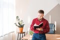 Businessman writing notes while sitting at his desk. Young bearded man Royalty Free Stock Photo