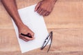 Businessman writing on paper at desk Royalty Free Stock Photo