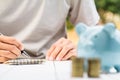 Businessman Writing paper and using calculator Calculating bonusOr other compensation to employees to increase productivity. on Royalty Free Stock Photo